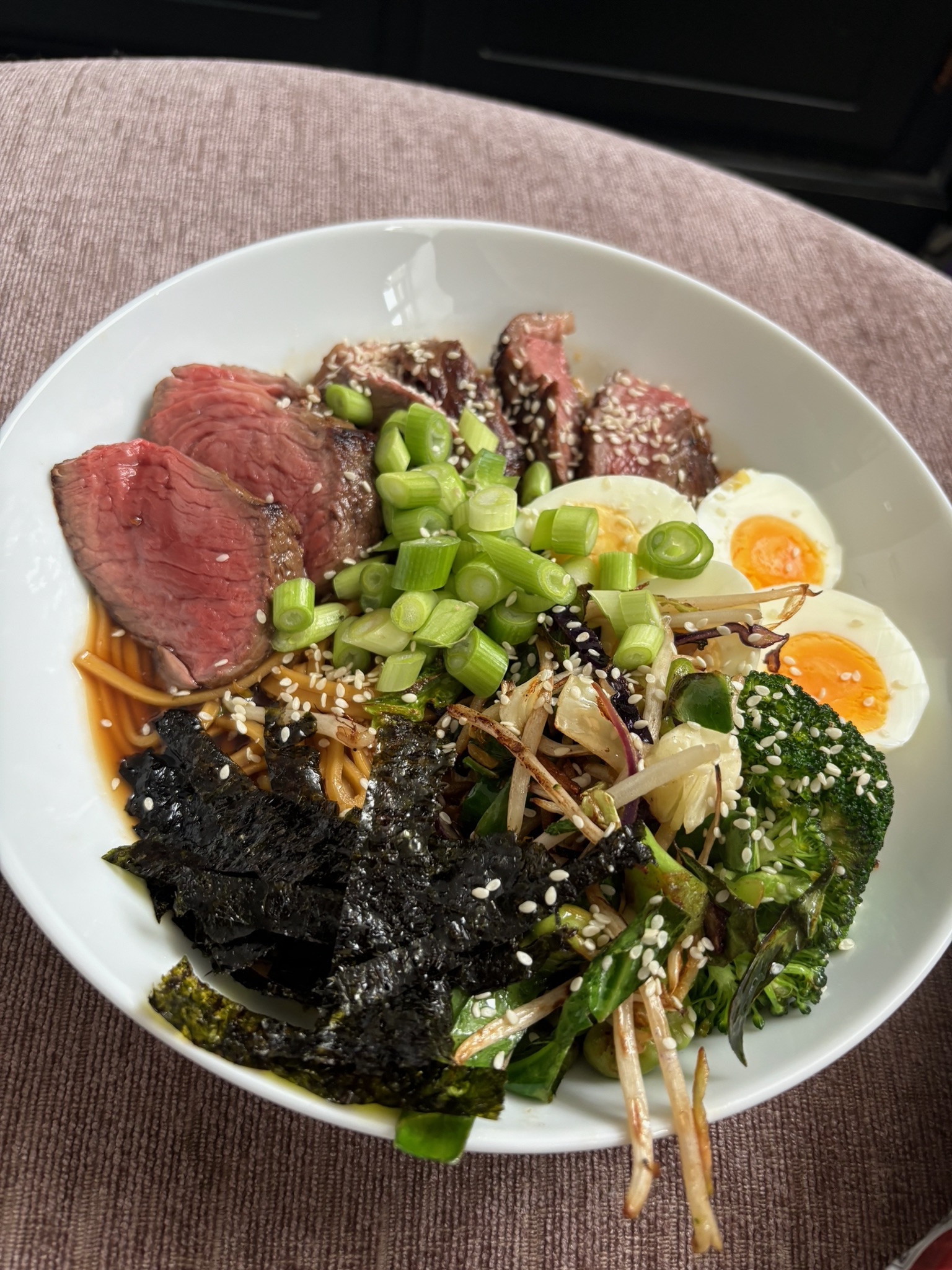 A balanced meal with steak, eggs, vegetables and noodles